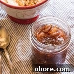 Spiced Fig Jam for Canning: Homemade Preserving Recipe 6 A jar filled with fig jam, with a spoon.
