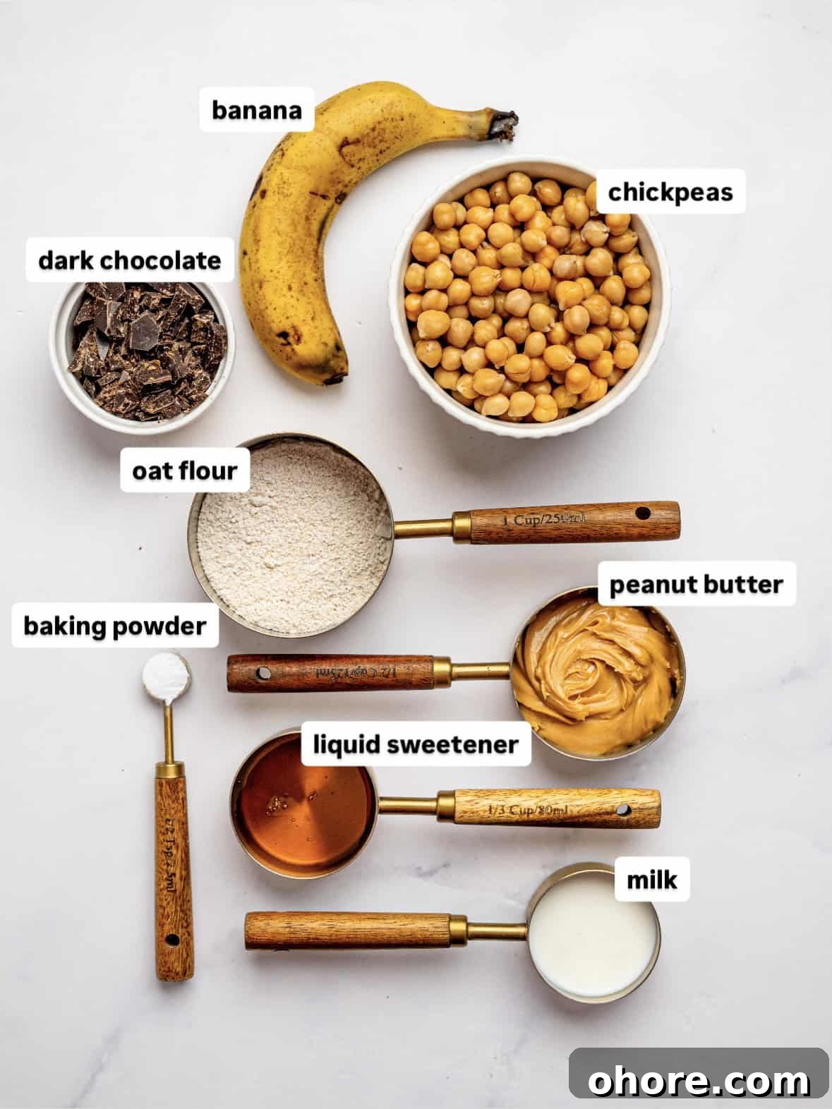 Gooey Chickpea Cookie Bars — Protein-Packed Dessert Bars 4 Ingredients needed to make chickpea cookie bars laid out on a counter top.
