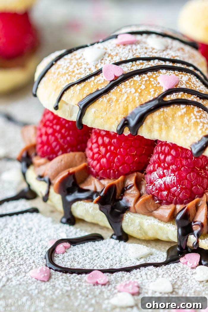 Flaky Puff Pastry Hearts for Valentine’s Day Gifts 8 Elegant Valentine's Day pastry filled with raspberries and chocolate cream, topped with powdered sugar, chocolate drizzle and heart-shaped sprinkles.