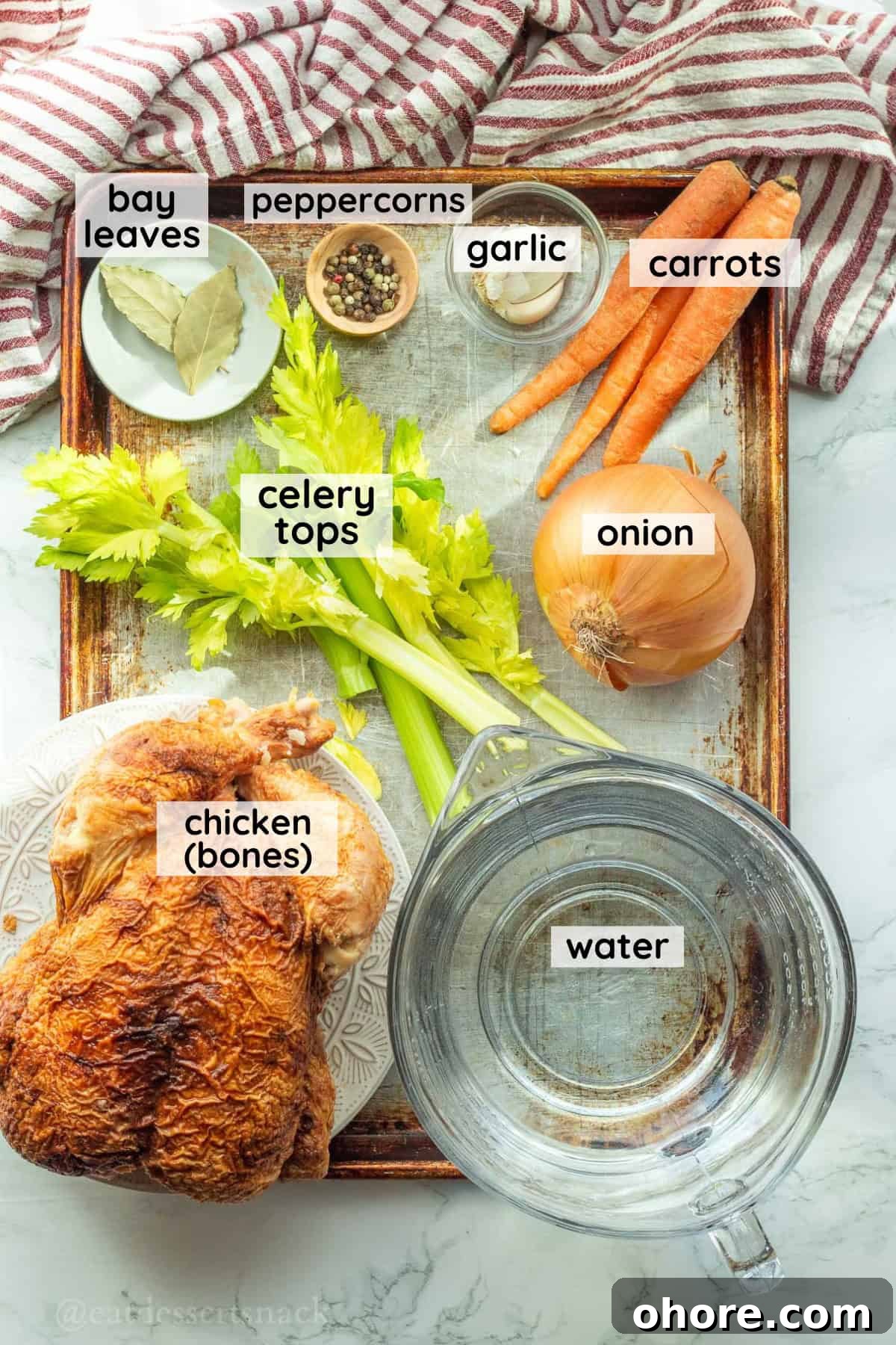 Homemade Instant Pot Chicken Bone Broth Recipe 3 Labeled ingredients for chicken bone broth on metal pan.