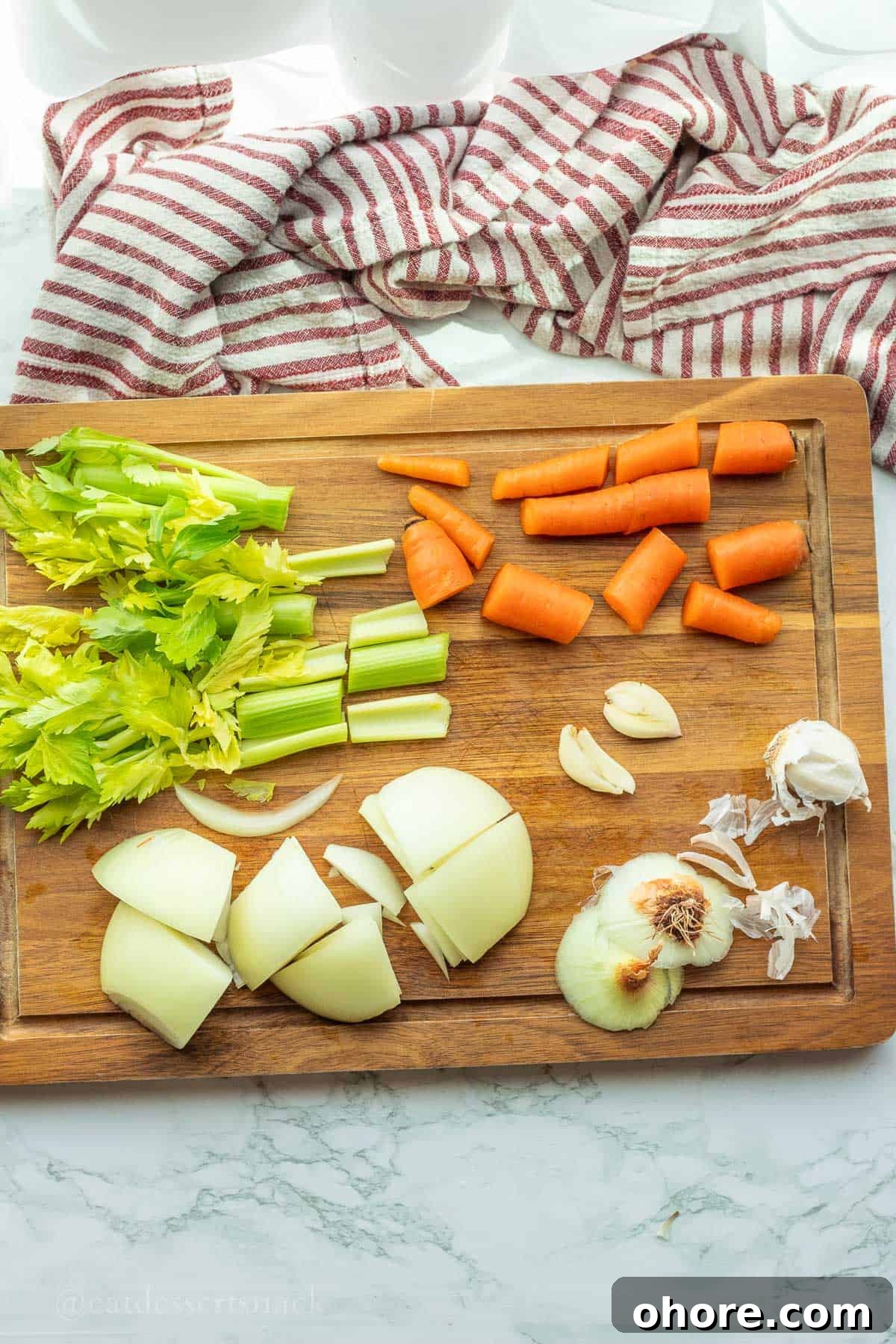 Homemade Instant Pot Chicken Bone Broth Recipe 4 Chopped vegetables on wood cutting board.