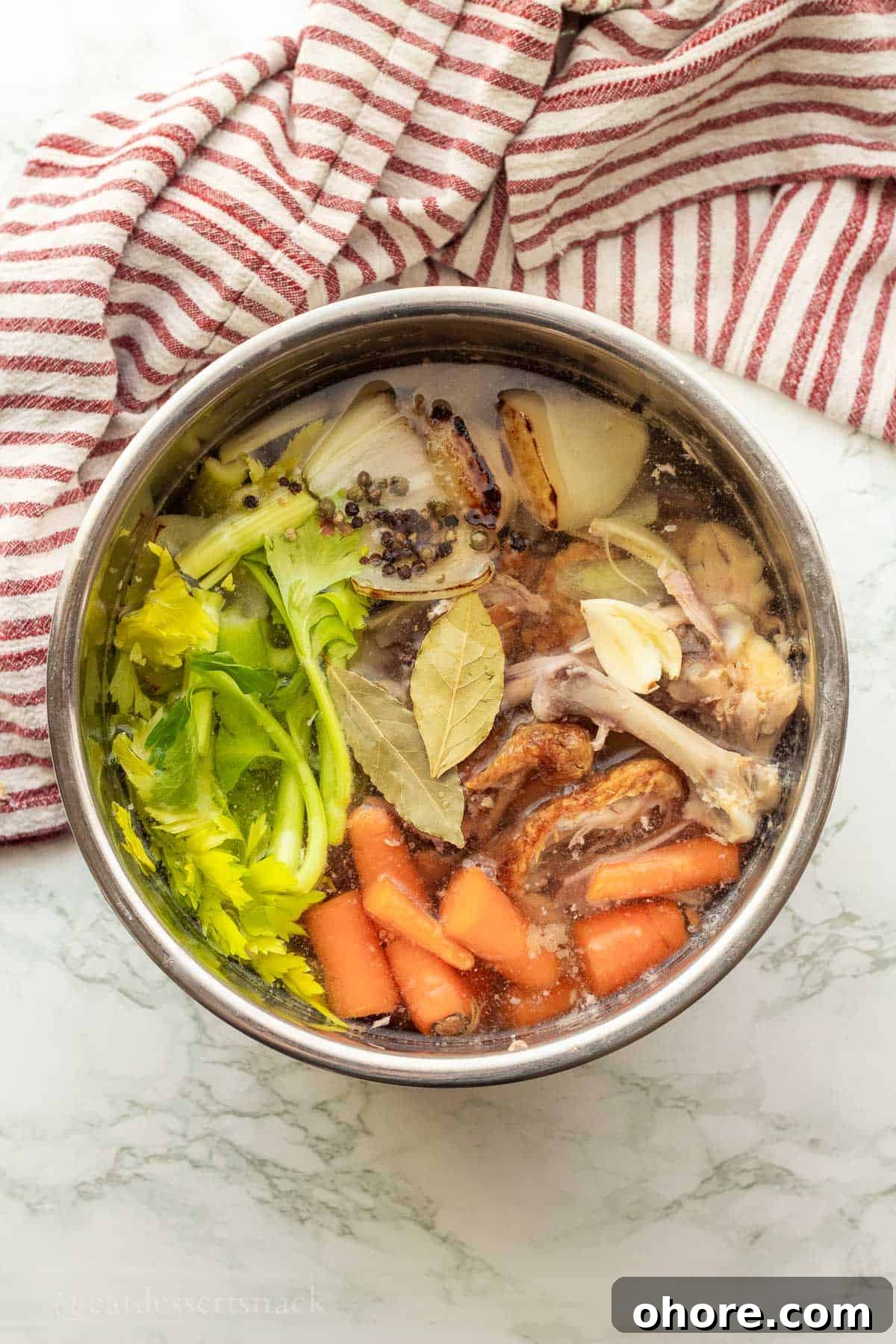 Homemade Instant Pot Chicken Bone Broth Recipe 6 Raw veggies in water in instant pot liner.