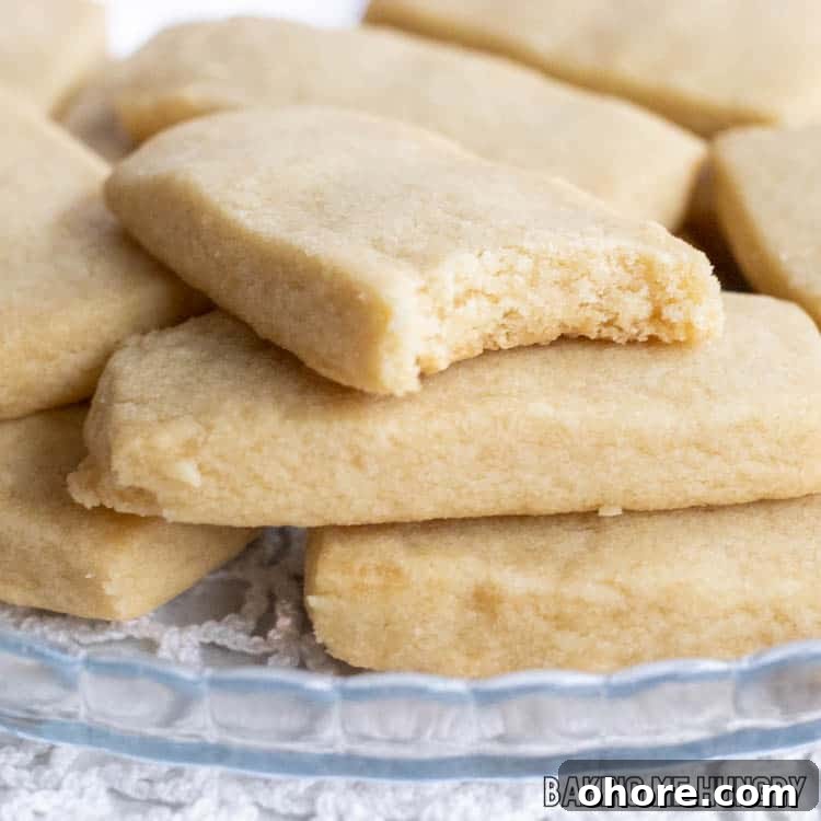 3-Ingredient Brown Sugar Cookies Recipe 2 one of the 3 Ingredient Brown Sugar Cookies missing a bite on top of a stack of cookies