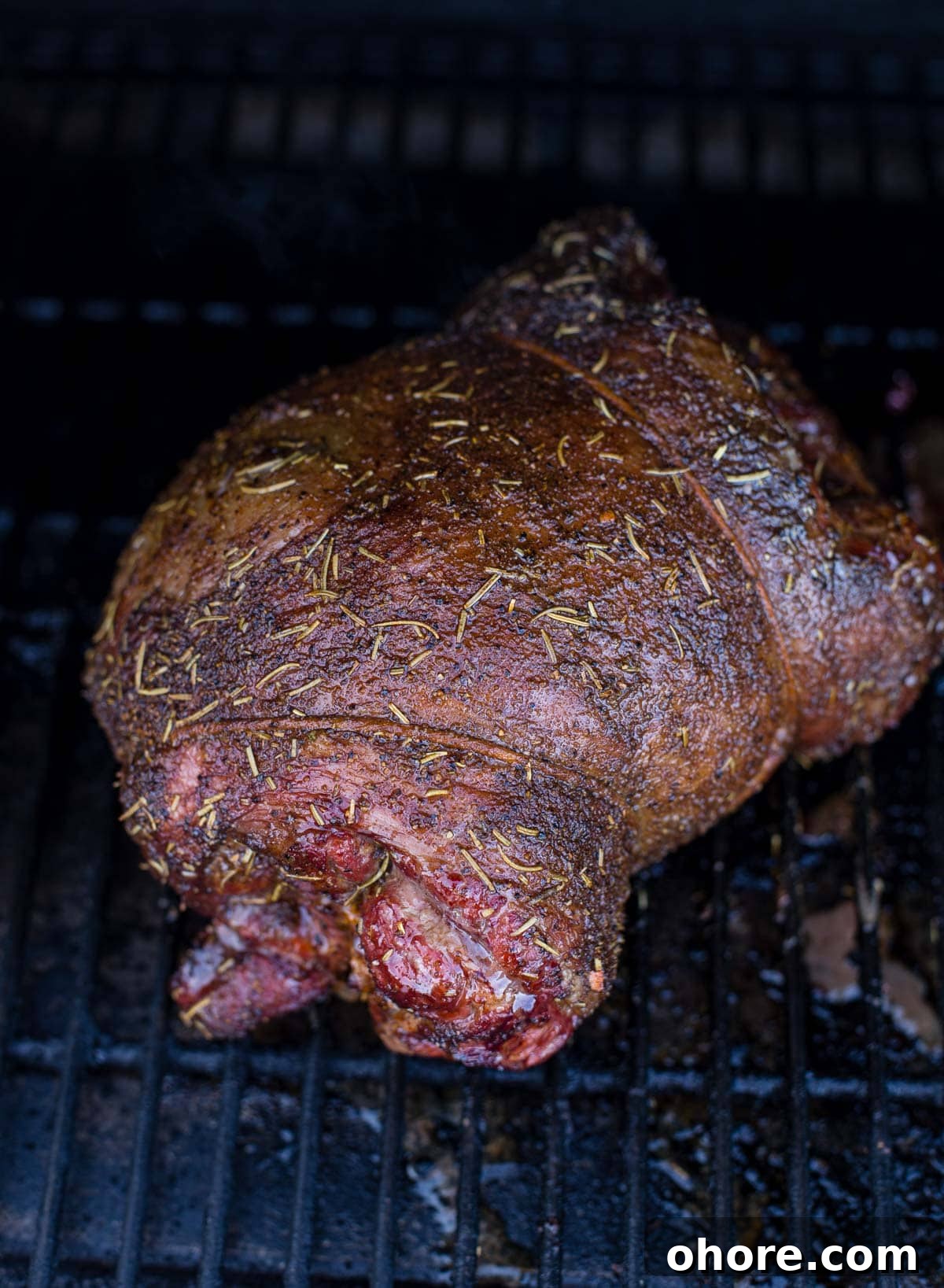 Smoked Boneless Leg of Lamb with Garlic Herb Rub 5 A boneless leg of lamb cooking on a smoker