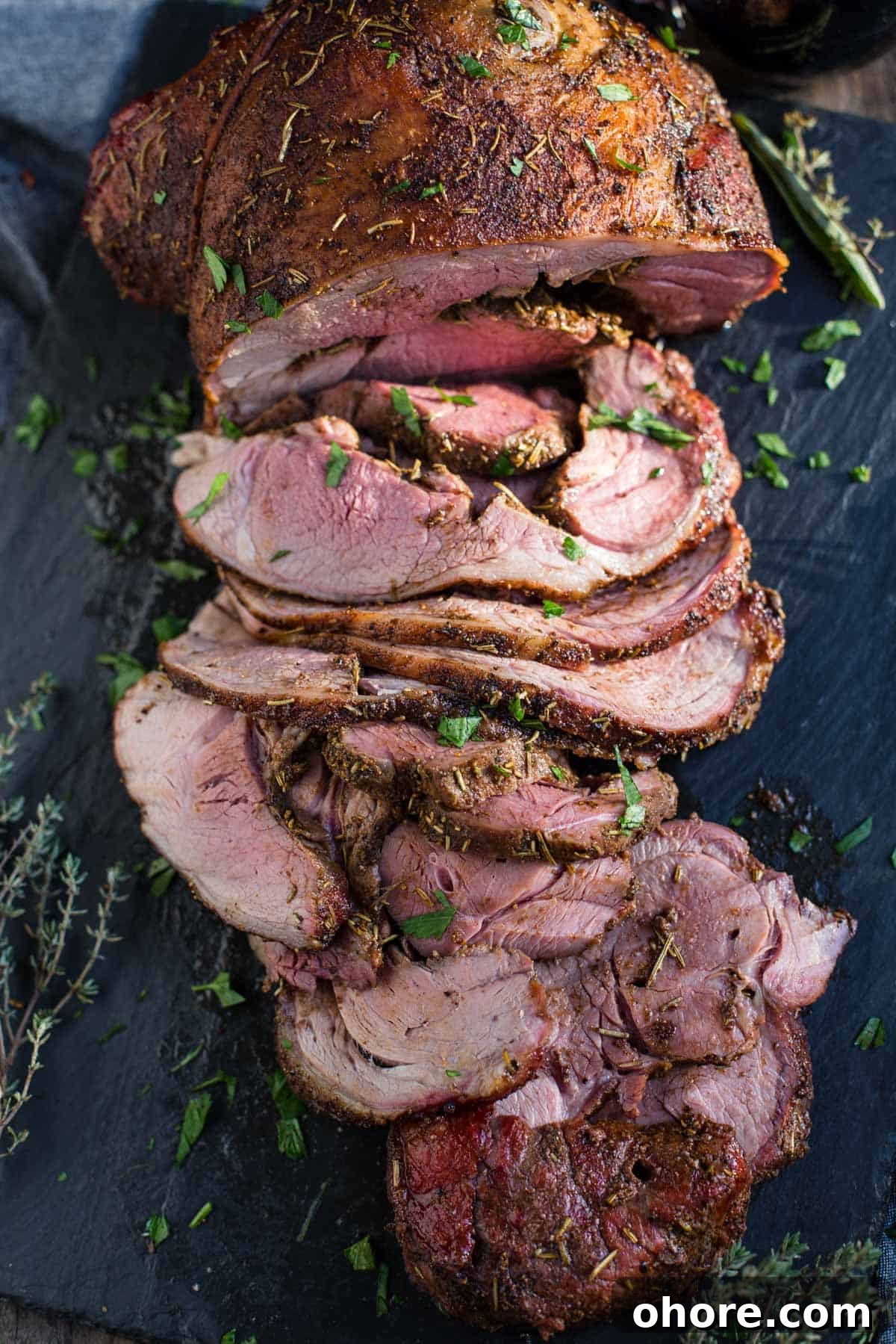Smoked Boneless Leg of Lamb with Garlic Herb Rub 6 Slices of boneless smoked leg of lamb on a platter