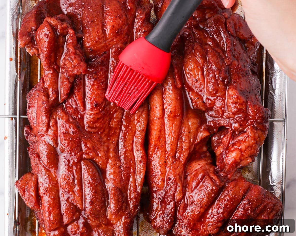 Char Siu Chinese BBQ Pork Recipe: Authentic Cantonese Roast Pork 11 Flipping pork