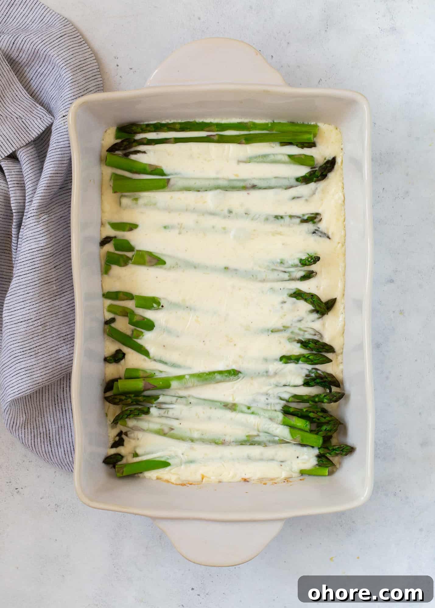 Creamy Asparagus Casserole Recipe for Spring Dinner 11 Cheese sauce added to asparagus.