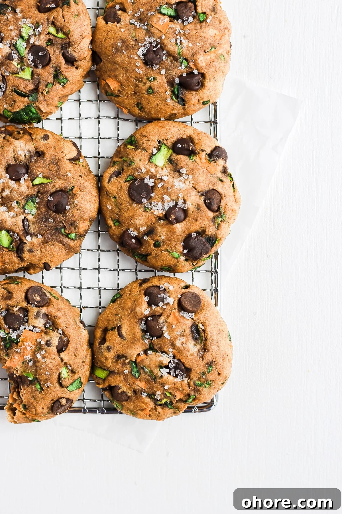 Wholesome Chocolate Chip Cookie Recipe That Melts in Your Mouth 2 Healthy Chocolate Chip Cookies on a cooling rack.