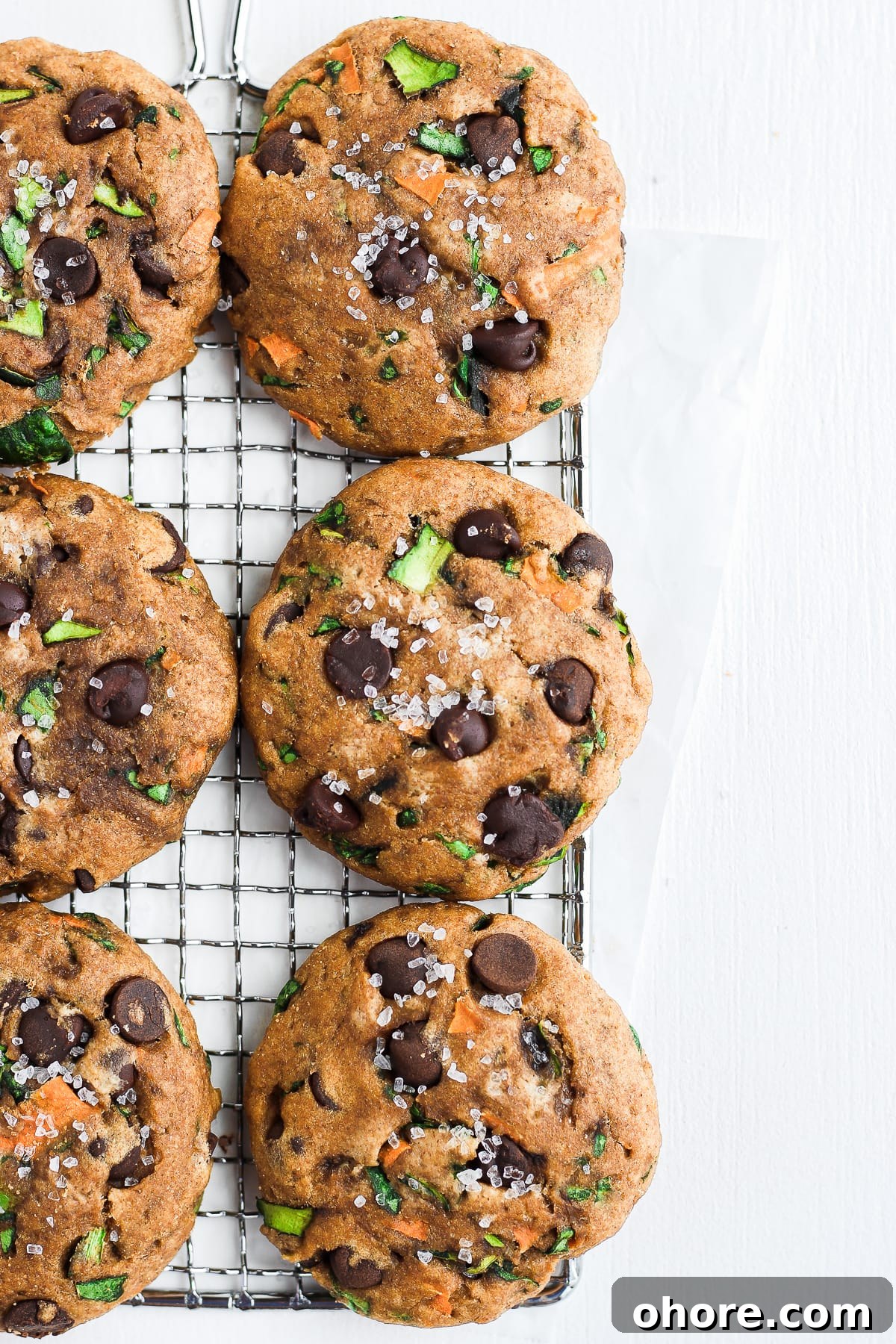 Wholesome Chocolate Chip Cookie Recipe That Melts in Your Mouth 4 Healthy Chocolate Chip Cookies lined up on a cooling rack.