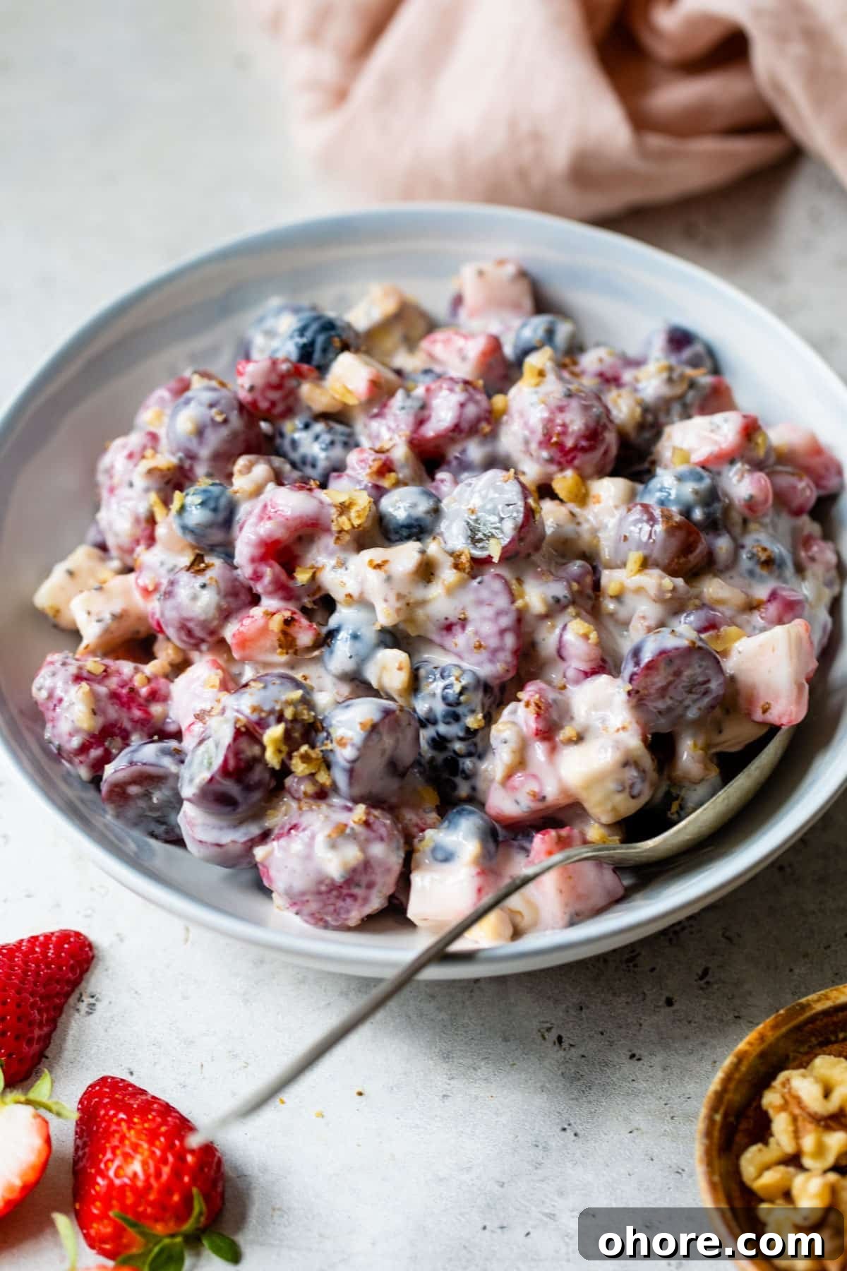Creamy Greek Yogurt Fruit Salad with Honey and Mint 2 greek yogurt fruit salad in a bowl with a spoon