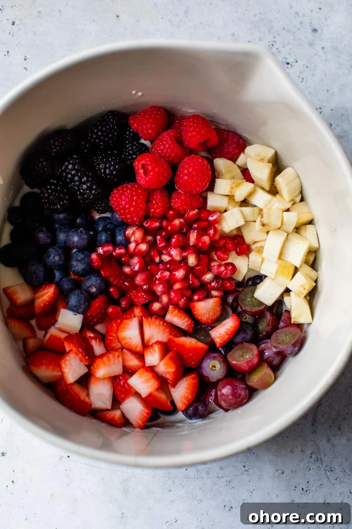 Creamy Greek Yogurt Fruit Salad with Honey and Mint 4 chopped fruit inside a large bowl