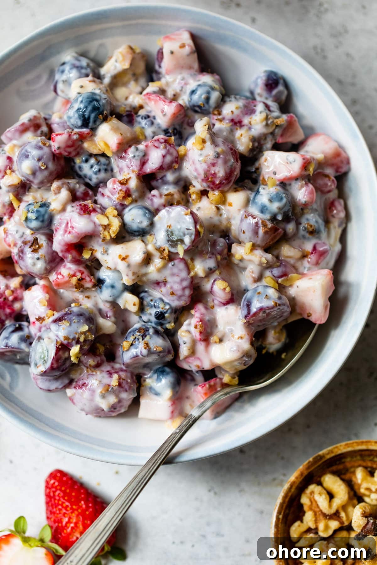 Creamy Greek Yogurt Fruit Salad with Honey and Mint 6 greek yogurt fruit salad in a bowl with a spoon