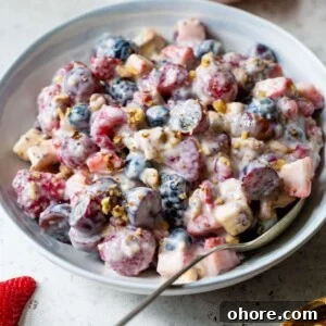 Creamy Greek Yogurt Fruit Salad with Honey and Mint 7 greek yogurt fruit salad in a bowl with a spoon