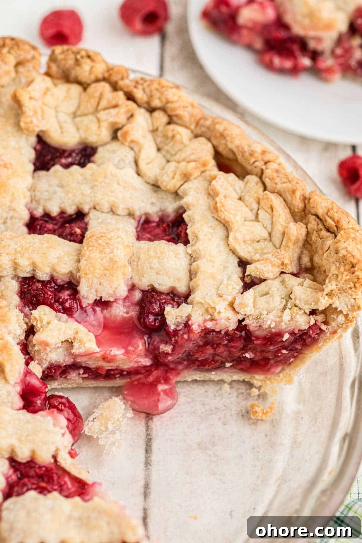 Homemade Raspberry Pie Recipe: Flaky Crust & Fresh Filling 12 Overhead close up of a raspberry pie, with a slice removed so you can see the delicious inside.