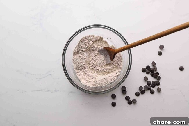Stirring flour and salt in a bowl.