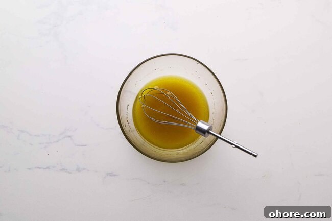 Mixing olive oil and sugar.