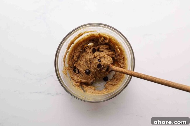 Stirring cookie dough in a bowl.