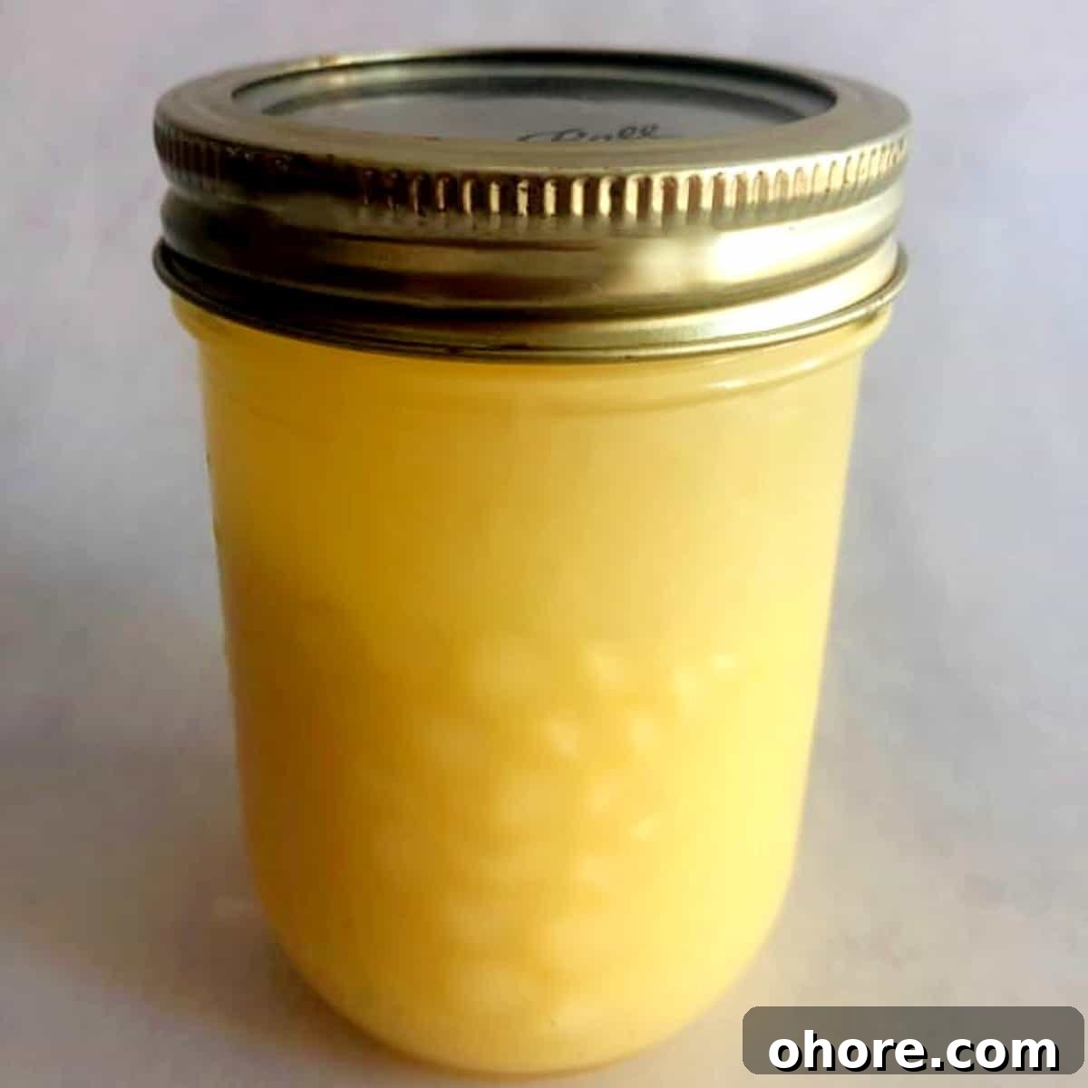 Homemade Meyer Lemon Curd Recipe — Bright Citrus Spread 3 homemade lemon curd in a mason jar.