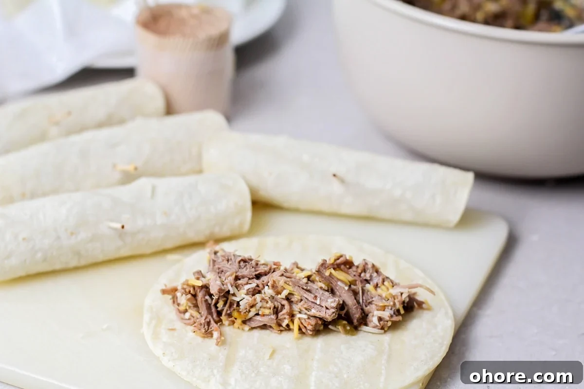 Crispy Chicken Flautas Recipe: Authentic Mexican Street-Style Tortillas 3 Beef mixture spread on a corn tortilla to make beef flautas recipe.