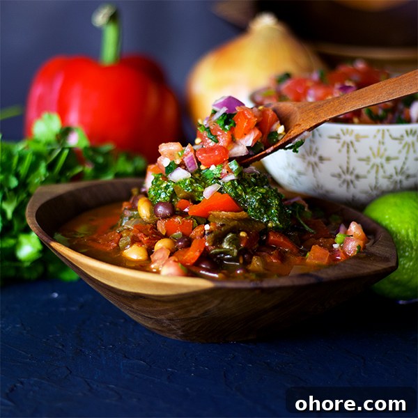 Vegetarian Chili with Fresh Pico de Gallo and Chimichurri 4 Spooning pico de gallo over a bowl of vegetarian chili.