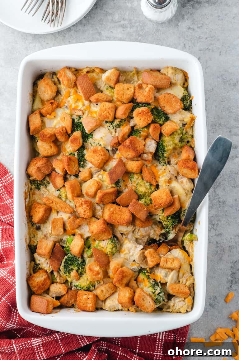 Festive Christmas Casserole Recipes for Holiday Gatherings 13 Top down view of the finished chicken broccoli casserole with serving spoon