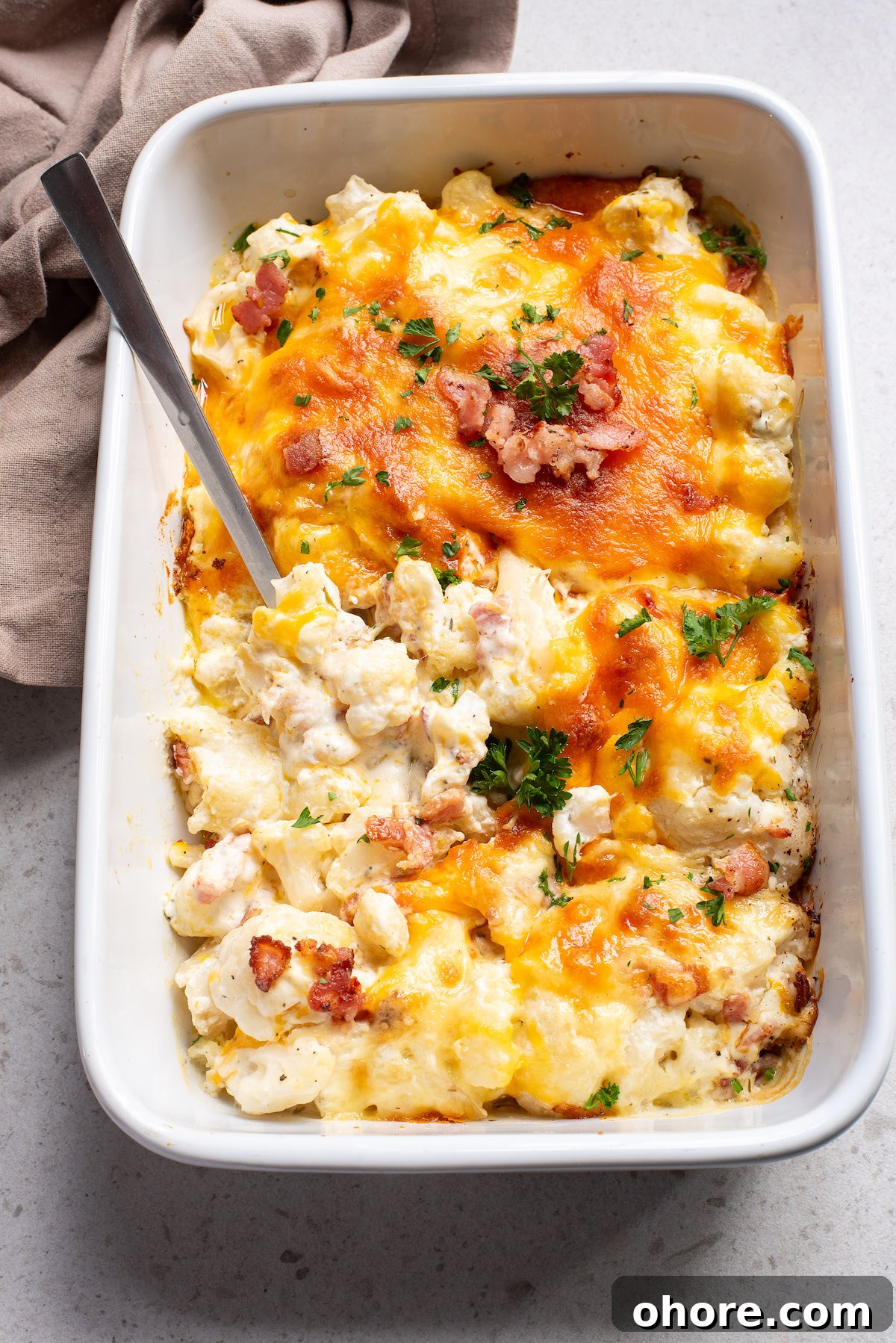 Festive Christmas Casserole Recipes for Holiday Gatherings 14 A serving spoon dipped inside the casserole