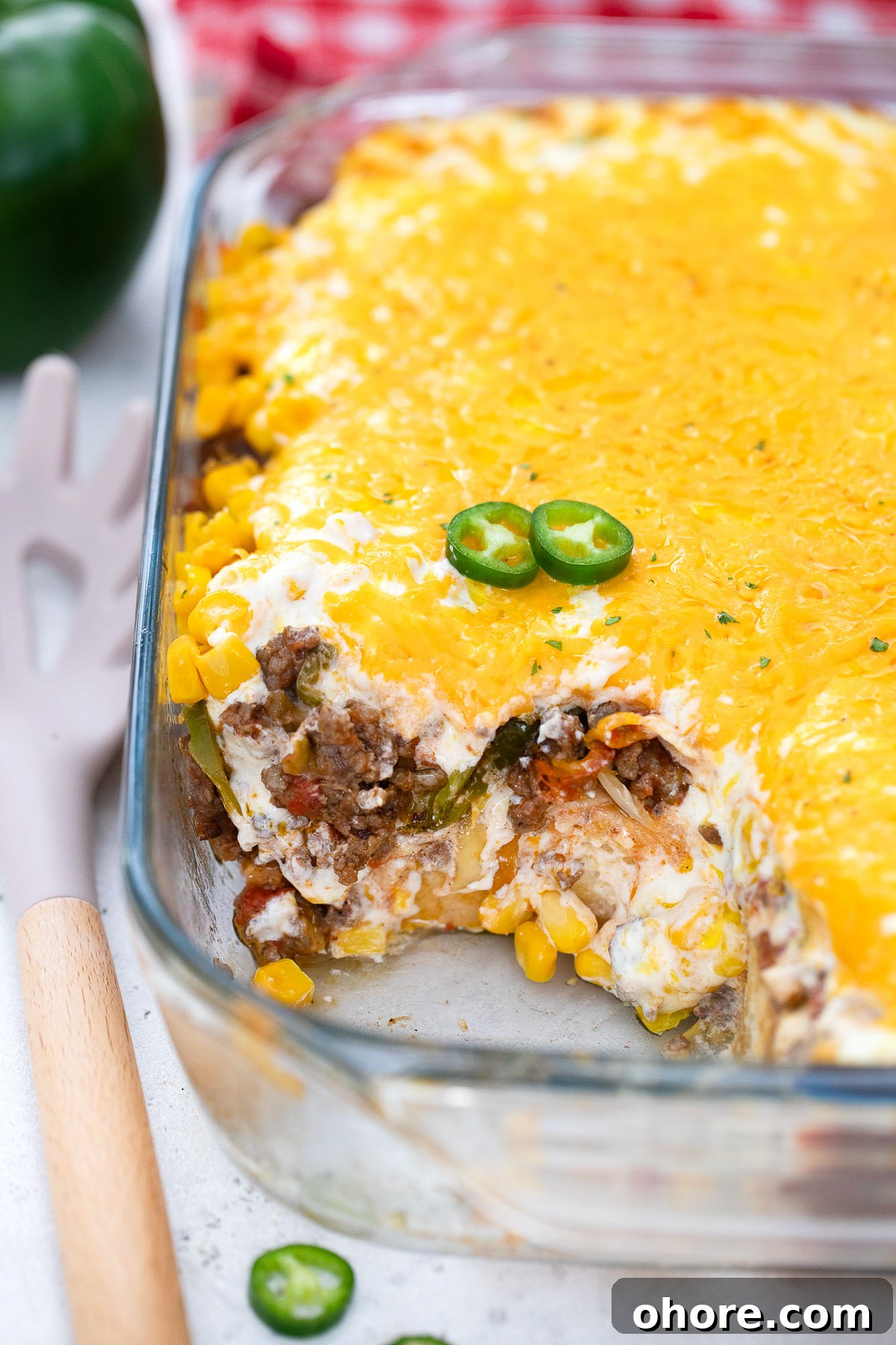 Festive Christmas Casserole Recipes for Holiday Gatherings 4 3/4 view of a John Wayne Casserole with a scoop out.