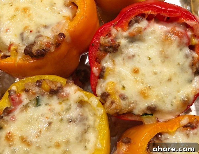 The BEST easy stuffed bell peppers recipe, ever! Using ground beef (or ground turkey), cheese, zucchini, corn, tomatoes and rice! Bake them in the oven, and enjoy this easy and healthy dinner recipe for the family. Instrupix.com