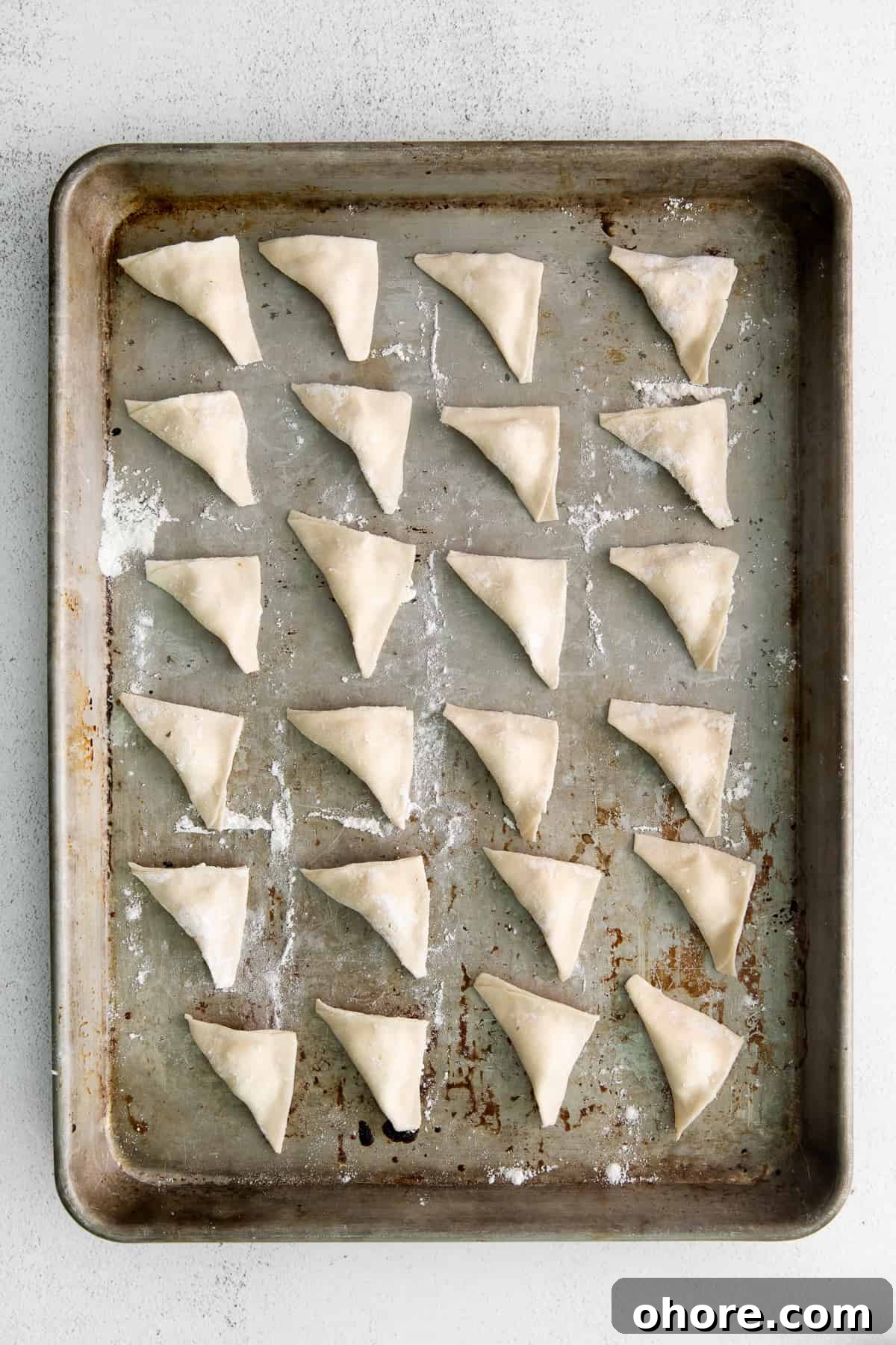 cheese tortellini on baking sheet