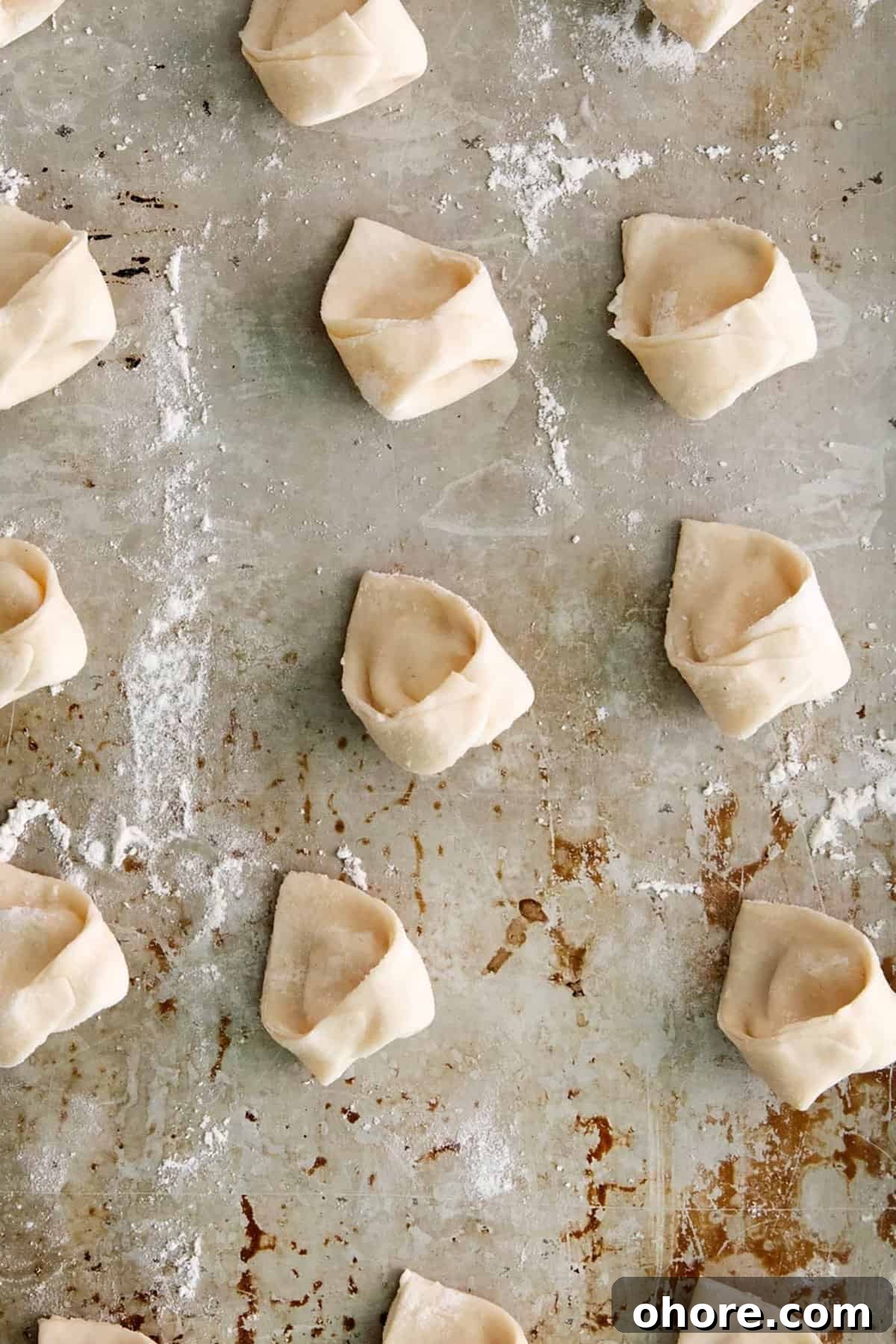 cheese tortellini on baking sheet. 