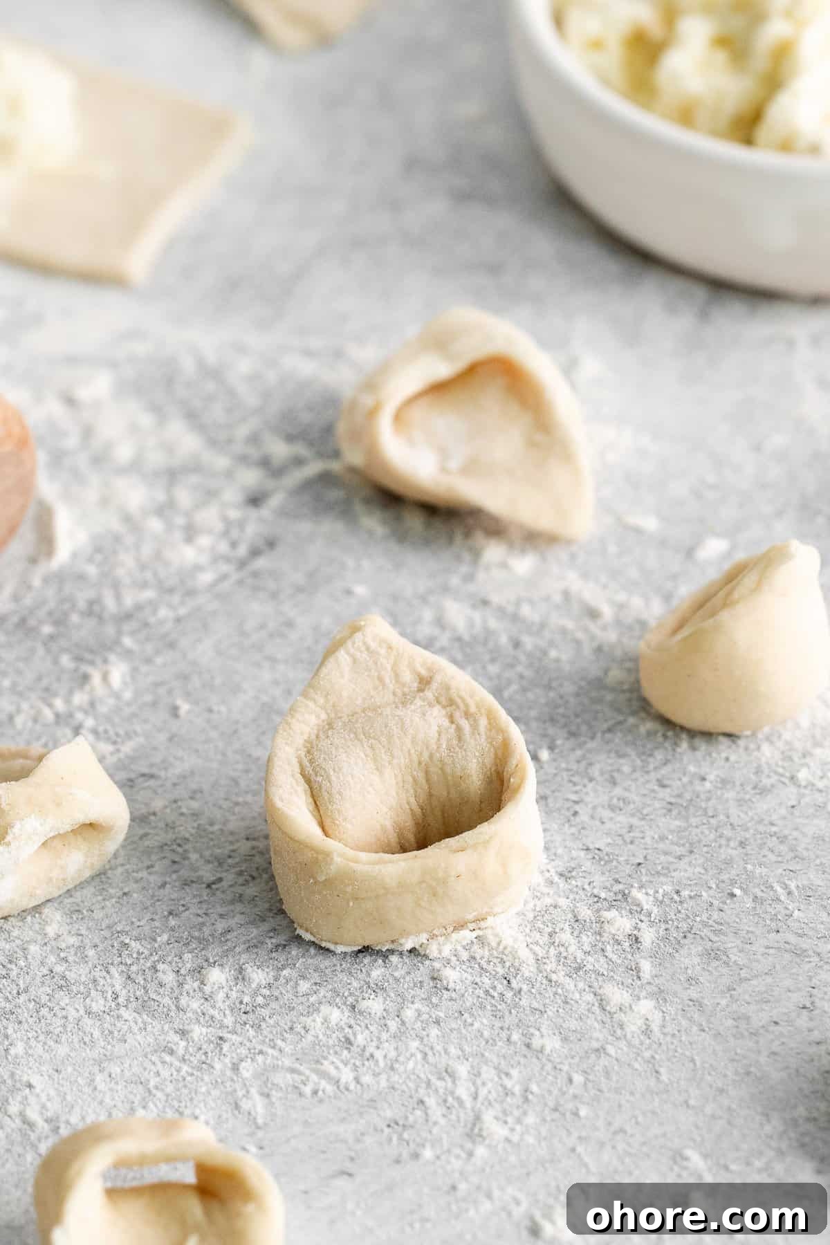 homemade tortellini on cutting board.