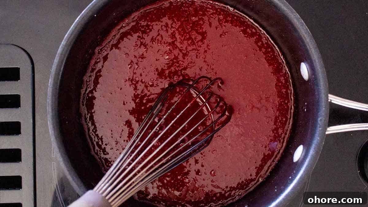 A saucepan containing a jello mixture. The jello is dissolved.