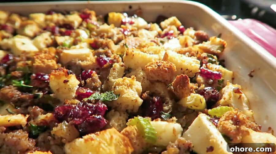 baking the sausage stuffing with apples, cranberries, and herbs