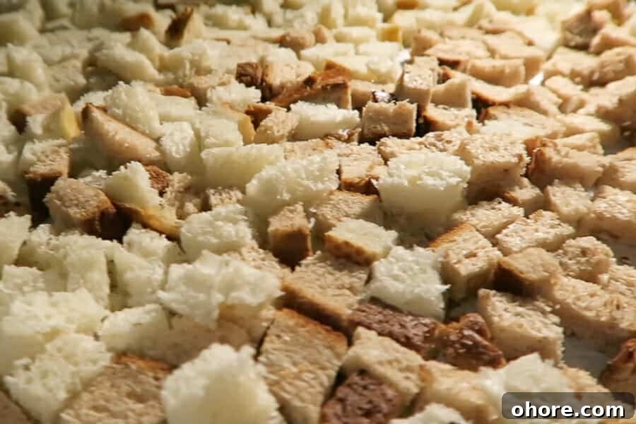 homemade bread cubes being baked in the oven for the sausage stuffing