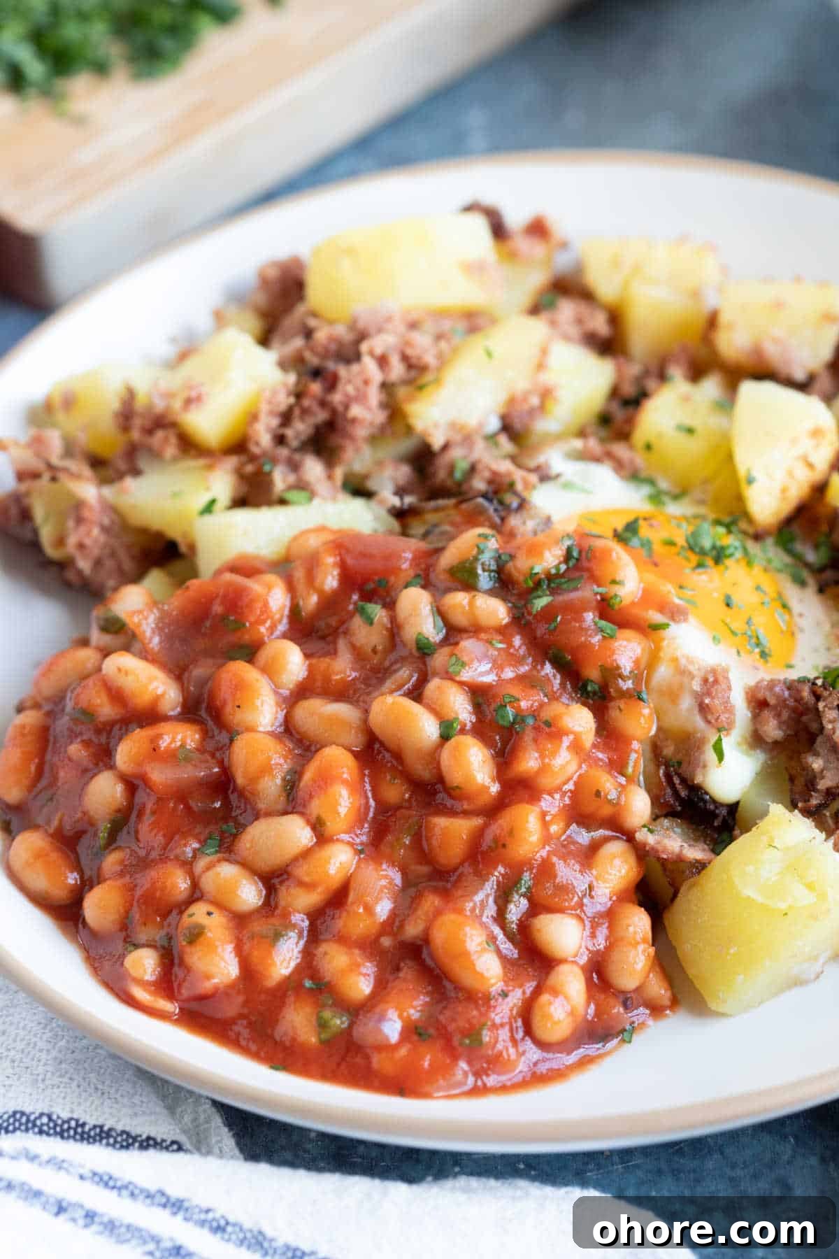 Authentic Homemade British Baked Beans Recipe for Breakfast 2 Homemade baked beans served with corned beef hash.