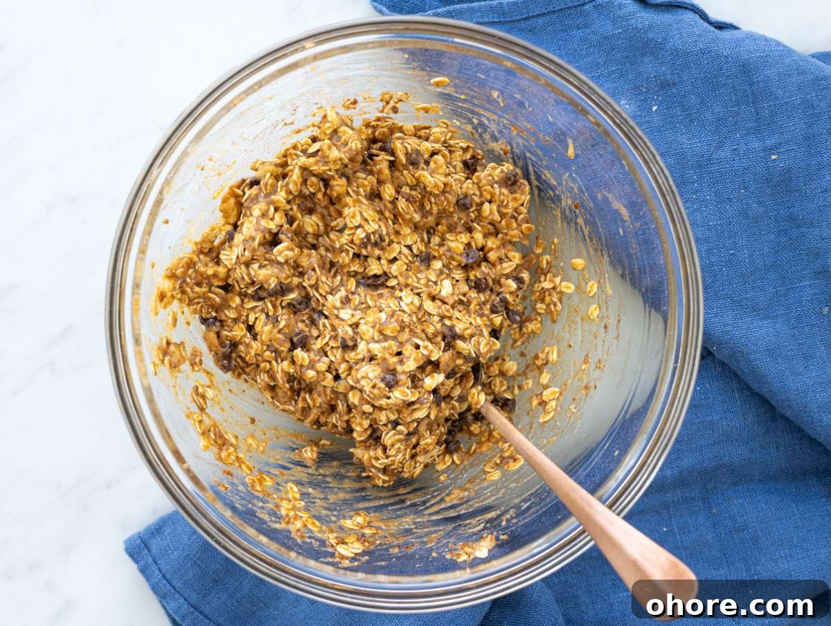 No-Bake Banana Bread Energy Balls — One-Bowl, No Blender Recipe 6 Step 2 Oats, nuts, and chocolate chips mixed into soft dough in bowl.