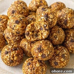 No-Bake Banana Bread Energy Balls — One-Bowl, No Blender Recipe 9 Banana bread energy balls stacked on a plate, bright natural light, clean marble background.