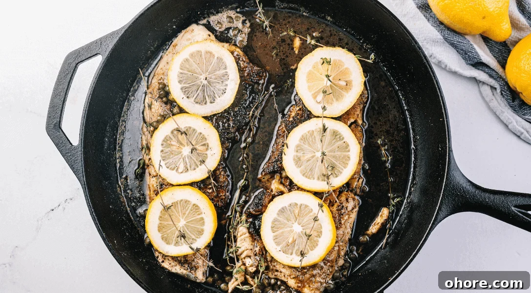 Fish Piccata with lemons in cast iron skillet