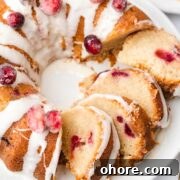 Cranberry Orange Bundt Cake with Zesty Citrus Glaze 13 Multiple slices of a glazed cranberry orange bundt cake on a plate.