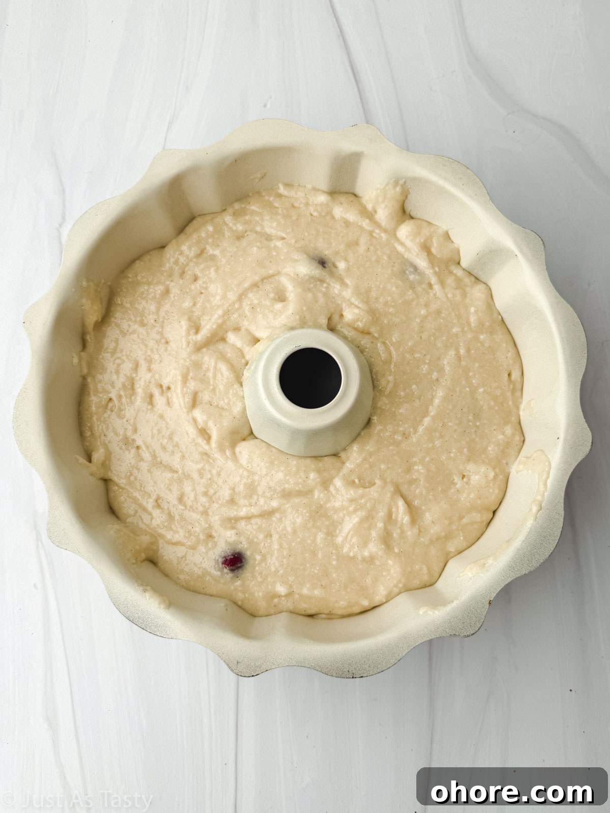Cranberry Orange Bundt Cake with Zesty Citrus Glaze 6 Cranberry orange cake batter in a bundt pan.