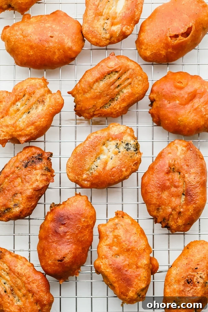 Crispy Beer-Battered Vegan Fish Fillets 3 pieces of golden brown fried vegan fish on a wire rack
