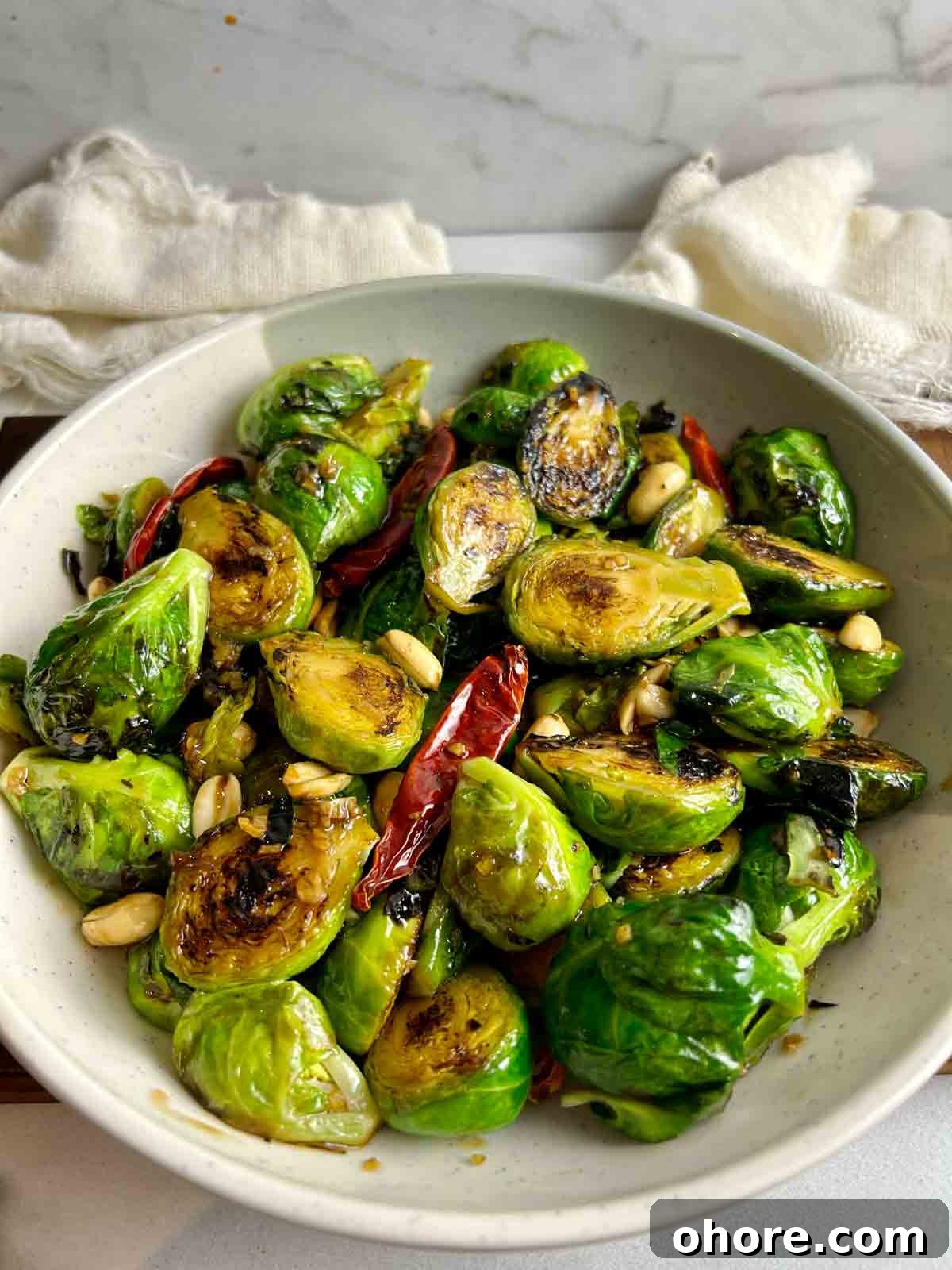 PF Chang's-Style Kung Pao Brussels Sprouts Recipe 11 side view of PF Chang's Brussels sprouts on plate.