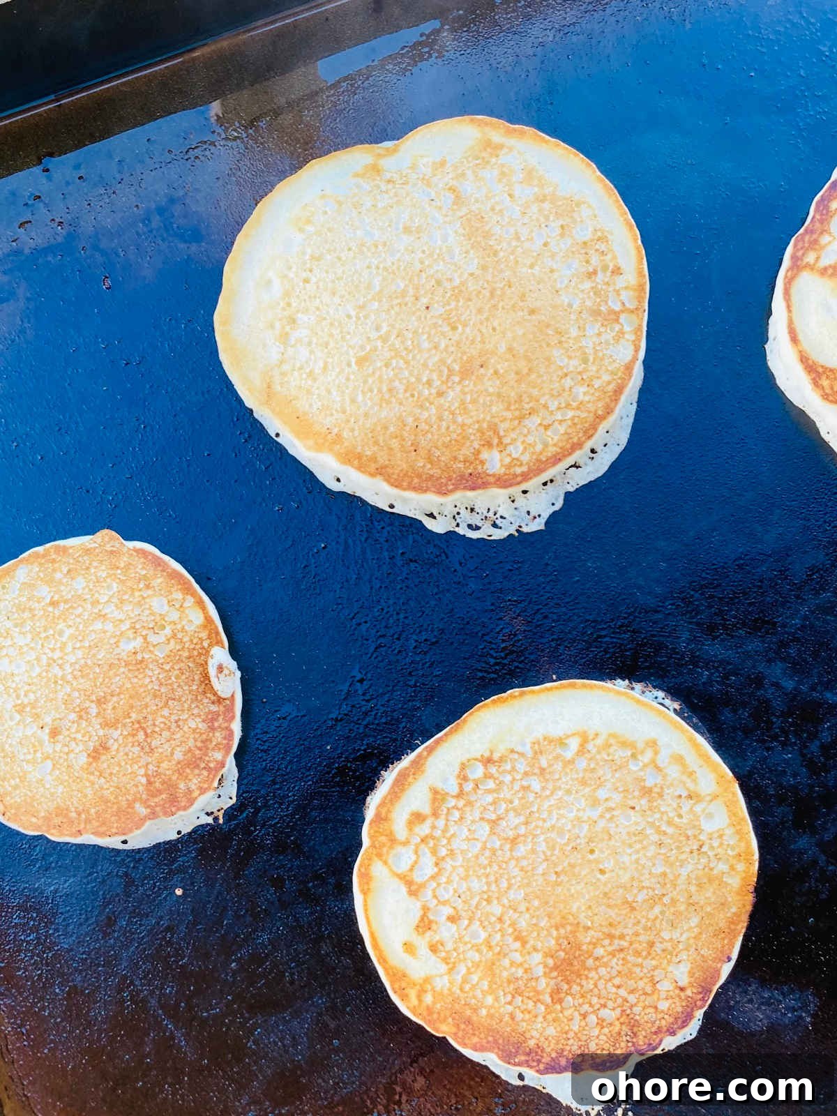 Fluffy Pancakes on a Blackstone Griddle: Perfect Morning Stack 4 pancakes on blackstone.