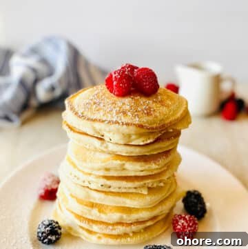 sweet cream pancake recipe on a plate with fresh berries