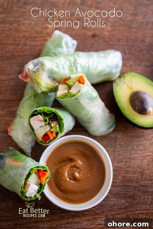 Chicken Avocado Spring Rolls cut in half on a cutting board
