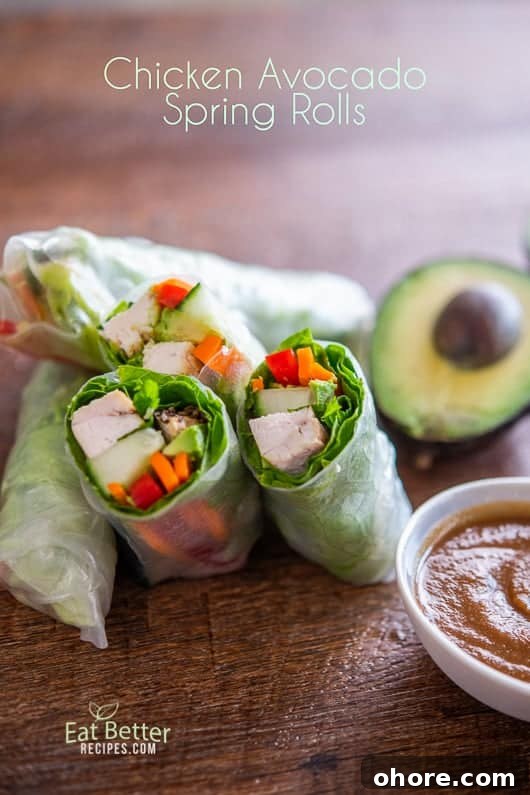 Chicken Avocado Spring Rolls cut in half on a board