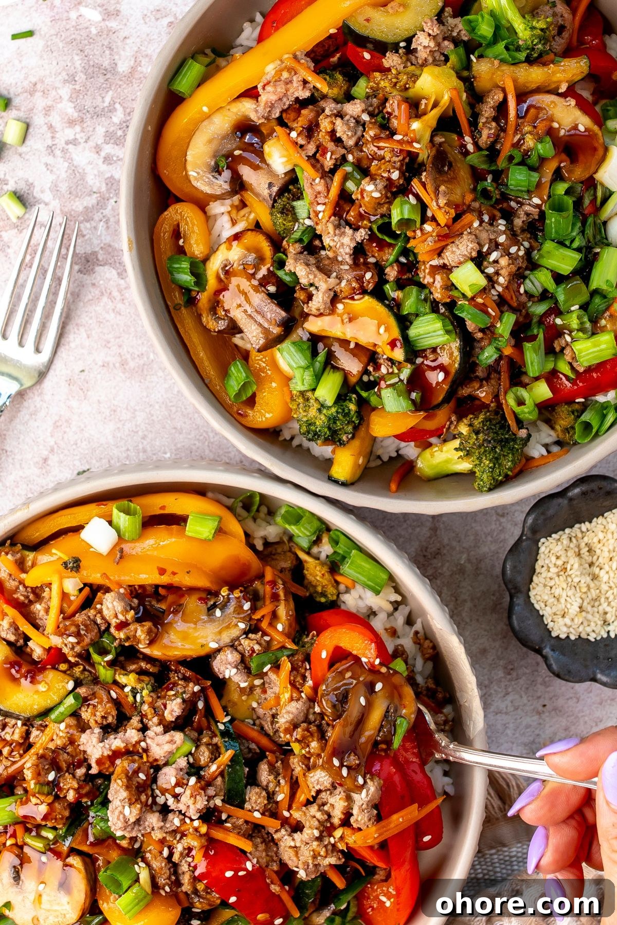Quick Garlic Ground Beef Stir-Fry Recipe for Weeknight Dinners 6 White bowl with ground beef Teriyaki over rice, up close.