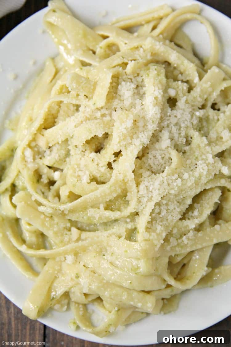 Delicious Pesto Alfredo, easy dinner recipe with fettuccine and homemade pesto alfredo sauce simple Pesto Alfredo with parmesan cheese in bowl