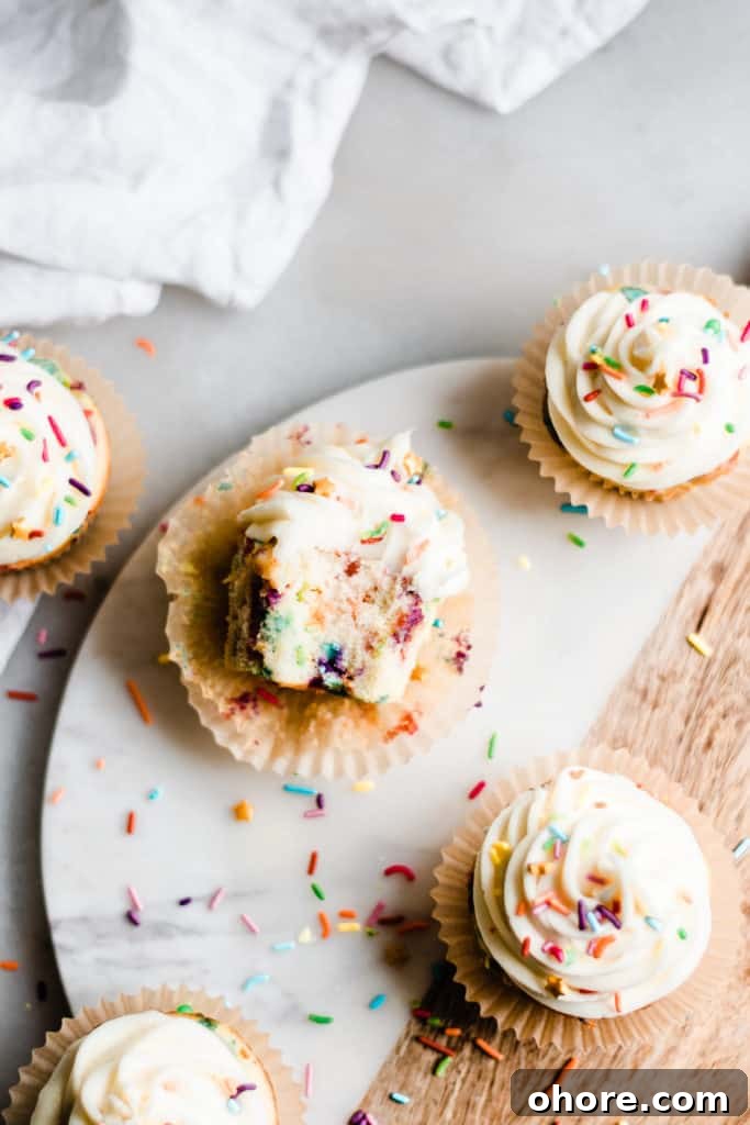 A bird's eye view of a cupcake with a bite missing.