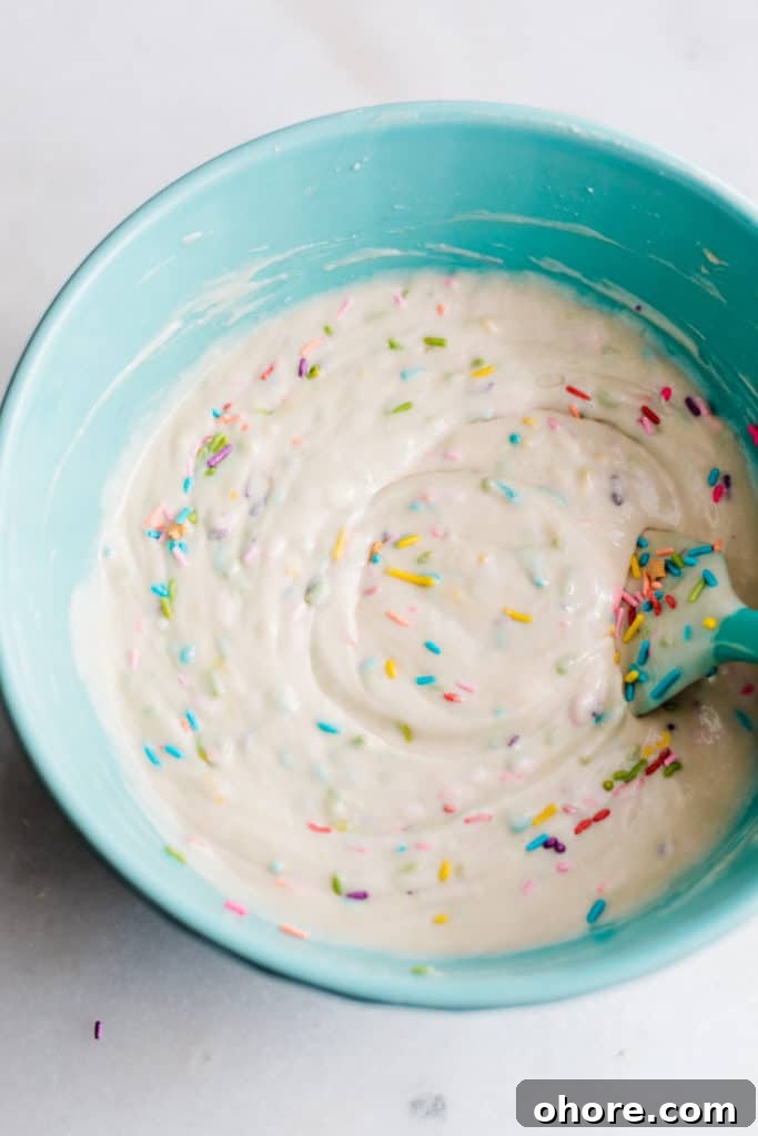 Batter with sprinkles in a blue bowl.